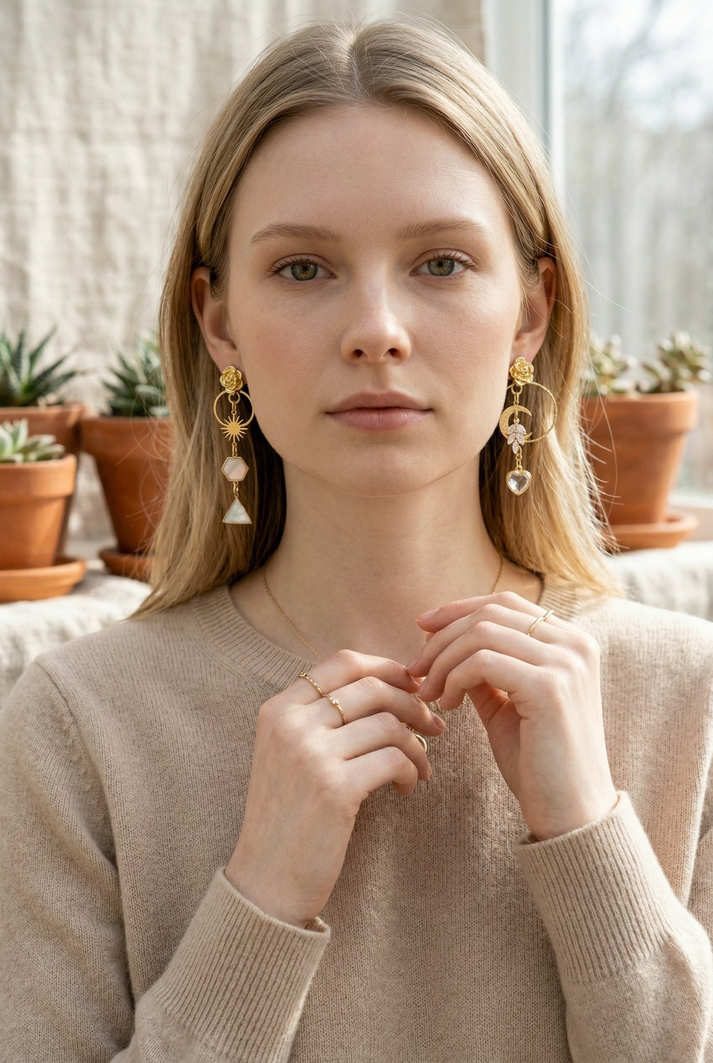 Lakelynns Designs asymmetrical gold-tone dangle earrings with rose, sun, moon, cubic zirconia, and heart charms.