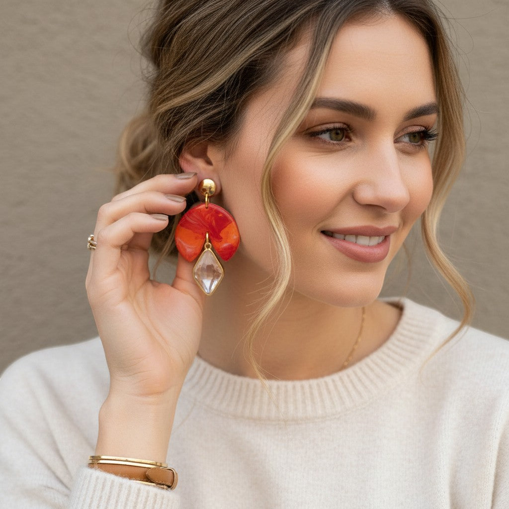 Lakelynns Designs Gracie fan earrings with marbled orange, red, and purple polymer clay and clear gemstone drop.