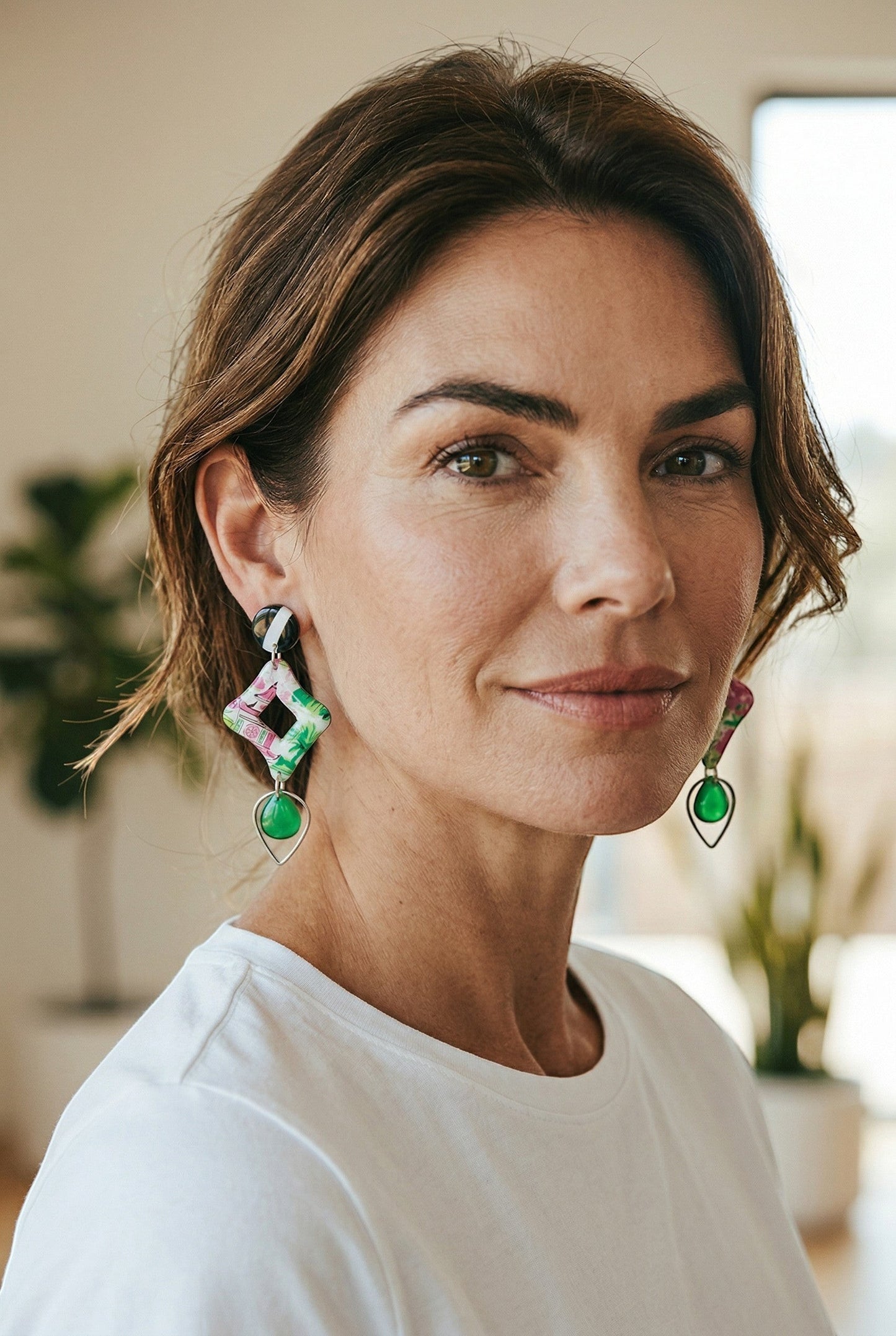 Lakelynns Designs Lennon statement earrings with black & white striped studs, floral diamond shapes, and emerald teardrop beads.