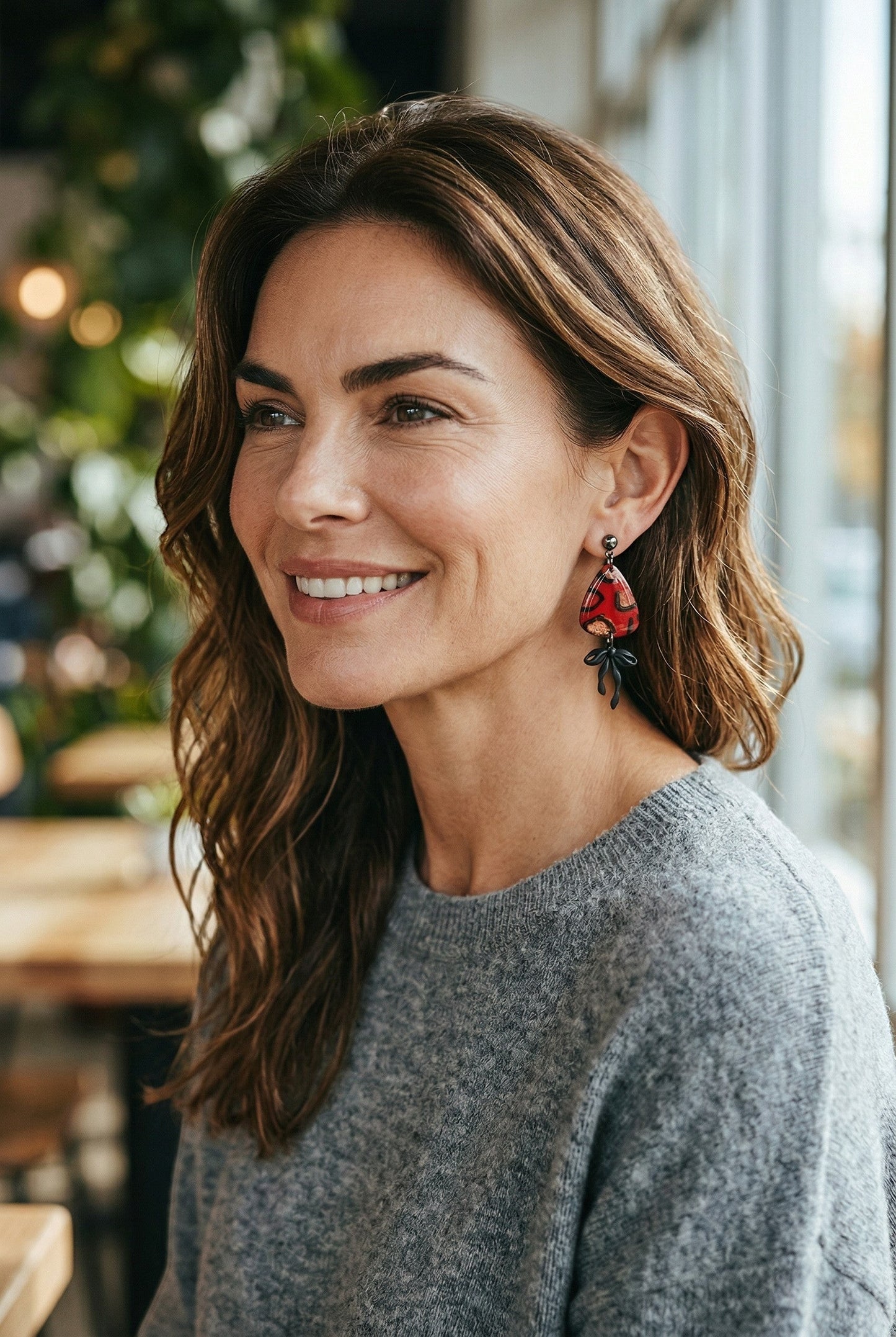 Lakelynns Designs red teardrop earrings with black abstract pattern and bow accent.
