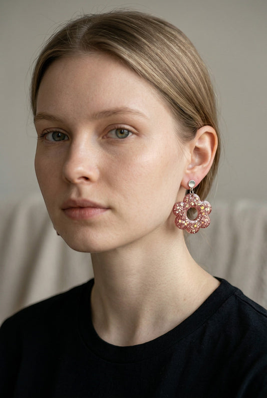 Lakelynns Designs rose gold glitter flower earrings with a central cutout, made of resin.