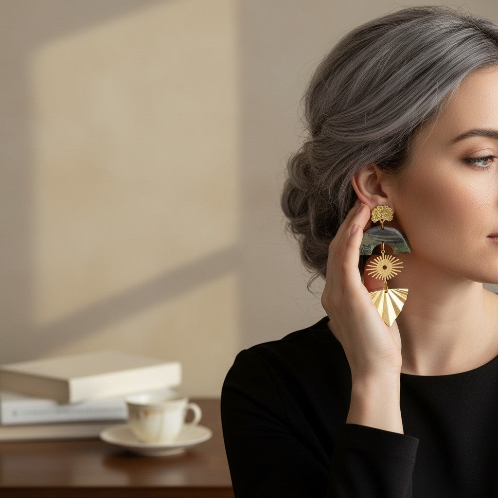 Lakelynns Designs layered statement earrings with gold-tone sunburst and fan shapes, green/brown arch top.