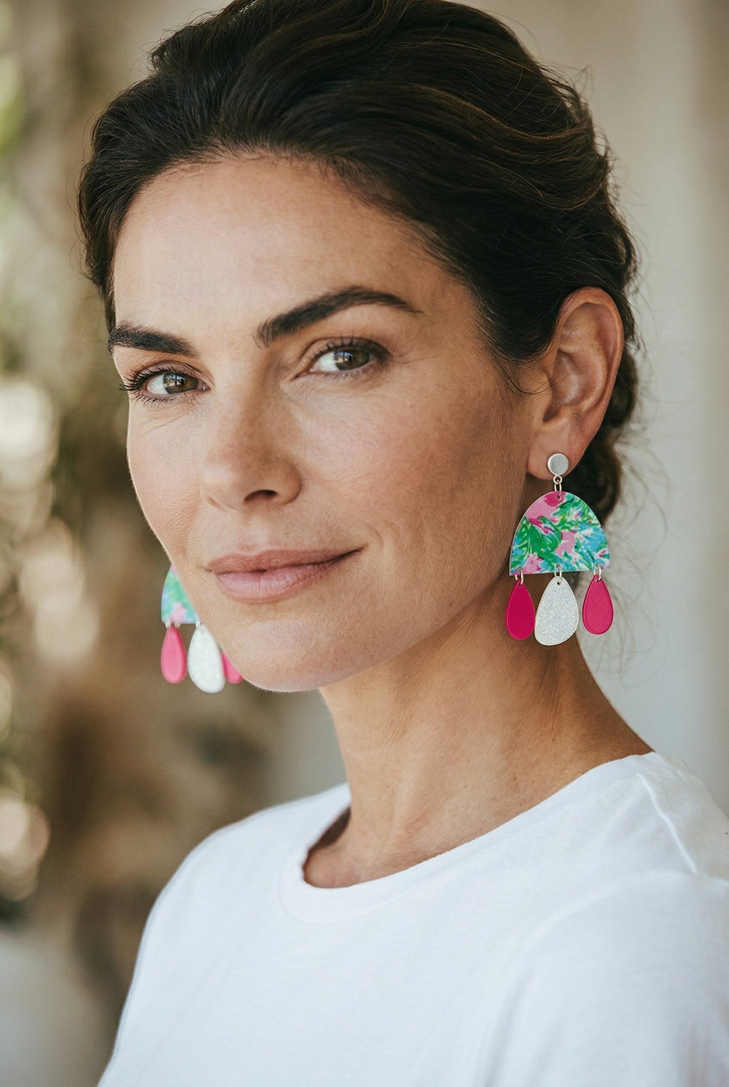 Lakelynns Designs Sky Tropical Arch Dangle Earrings with green palm leaves, pink hibiscus, and hot pink teardrops.