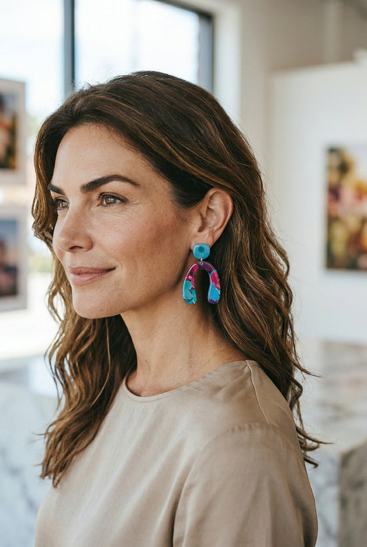 Lakelynns Designs vibrant abstract arch dangle earrings in pink, blue, and purple with a glossy finish.