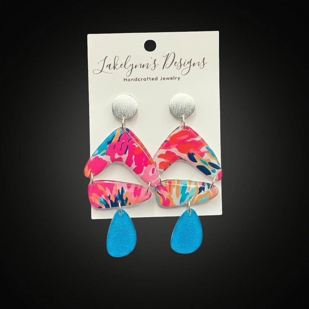 Lakelynns Designs abstract pattern dangle earrings with chevron, rectangle, and teardrop shapes in fuchsia, teal, orange, and blue.