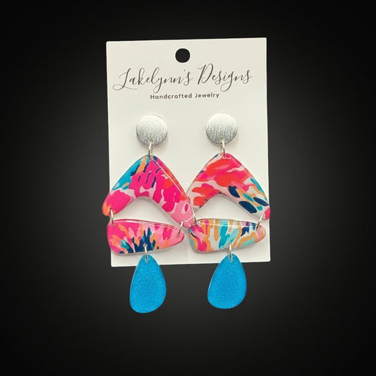 Lakelynns Designs abstract pattern dangle earrings with chevron, rectangle, and teardrop shapes in fuchsia, teal, orange, and blue.