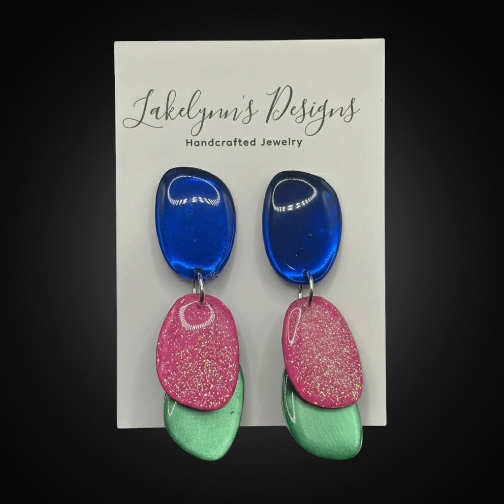 Lakelynns Designs abstract dangle earrings with royal blue, glittery hot pink, and mint green acrylic shapes.