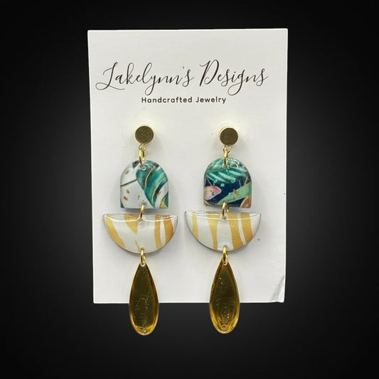 Lakelynns Designs abstract dangle earrings with tropical foliage, gold stripes, and teardrop pendants.