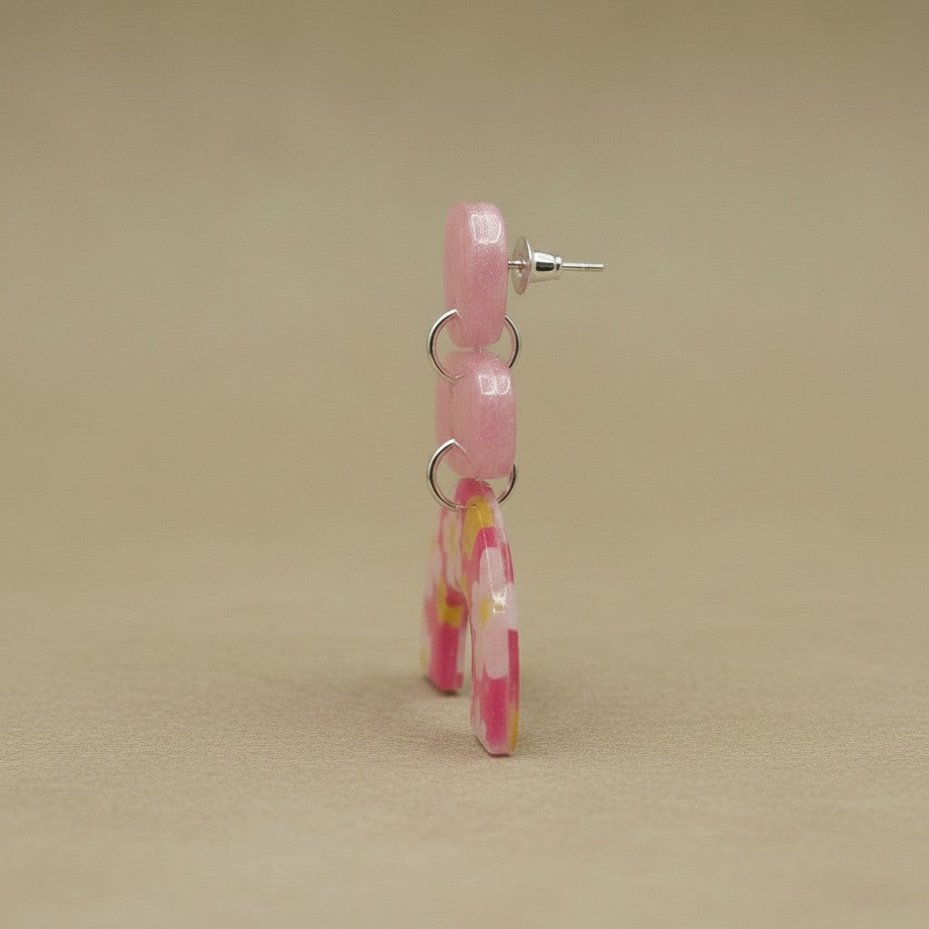 Lakelynns Designs abstract floral arch earrings in pink resin with floral accents and stacked arch design.
