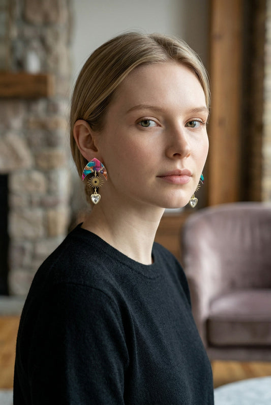 Lakelynns Designs abstract heart dangle earrings with sunburst charm and faceted heart pendant in pink, blue, and gold.