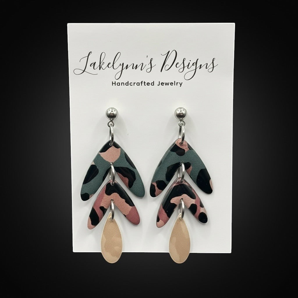 Lakelynns Designs abstract leaf dangle earrings in teal, dusty rose, black, and champagne. Polymer clay with hypoallergenic posts.