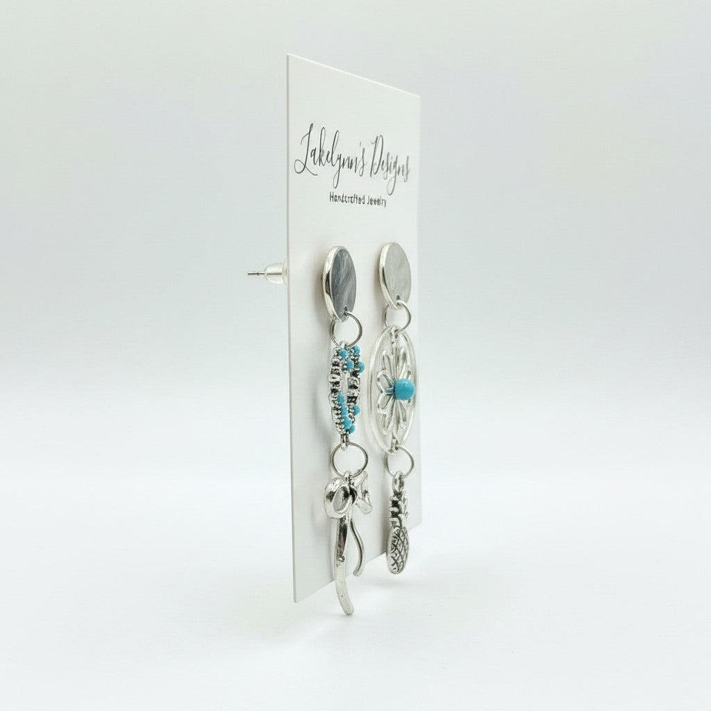 Lakelynns Designs asymmetrical silver-tone earrings with turquoise stones, flower, bow, and pineapple charms.