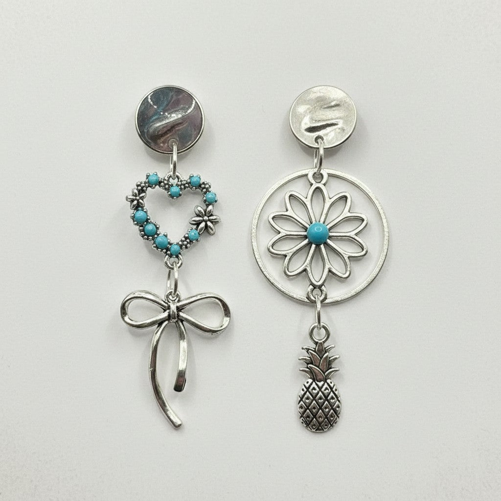 Lakelynns Designs asymmetrical silver-tone earrings with turquoise heart, bow, flower, and pineapple charms.
