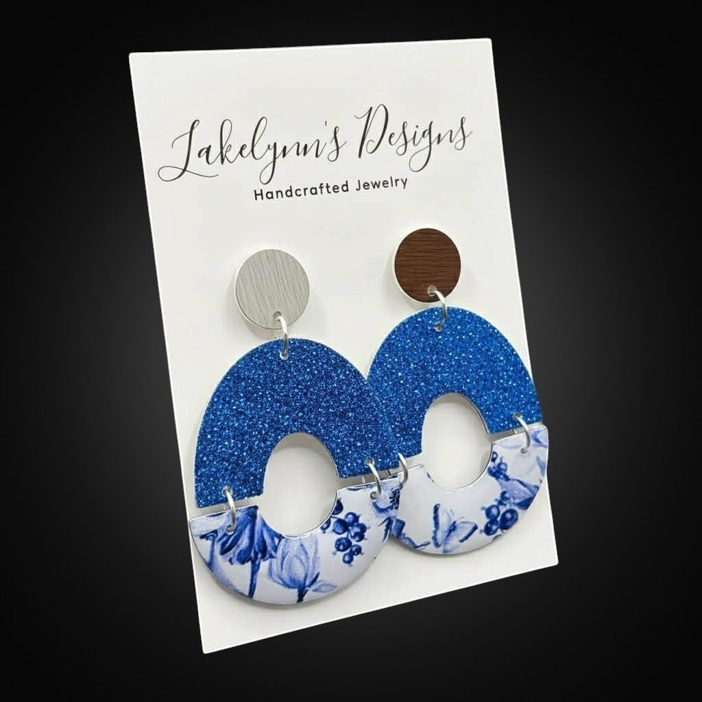 Lakelynns Designs handcrafted blue glitter oval earrings with blue floral print and wood stud accents.