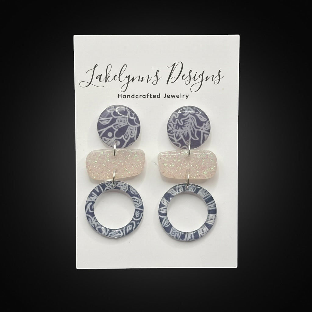Lakelynns Designs abstract geometric statement earrings with navy & white pattern circles and pastel glitter rectangles.