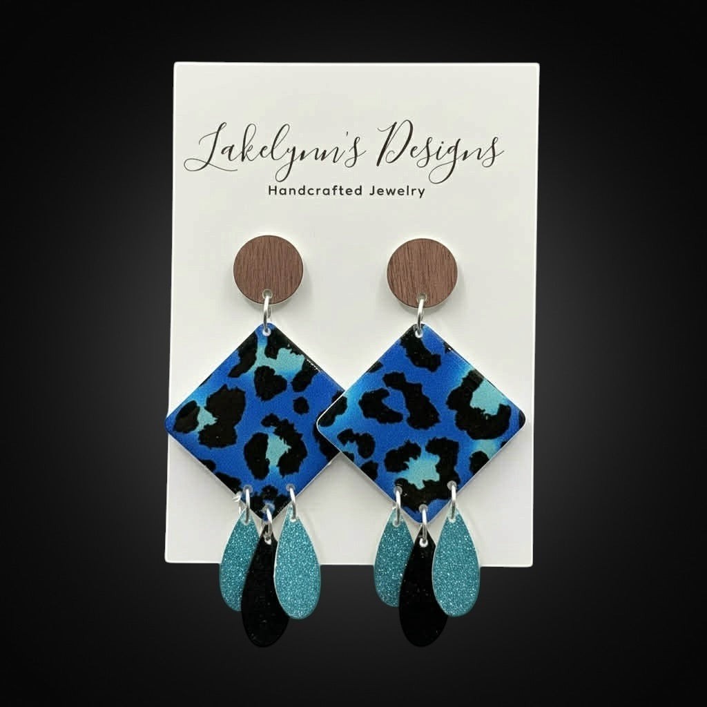 Lakelynns Designs blue leopard print diamond drop earrings with turquoise and black teardrop charms and wood beads.