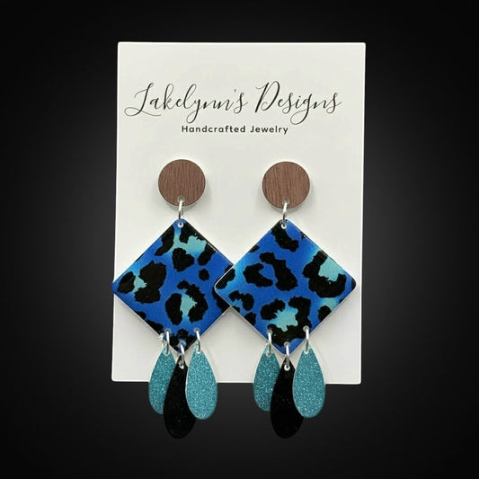 Lakelynns Designs blue leopard print diamond drop earrings with turquoise and black teardrop charms and wood beads.
