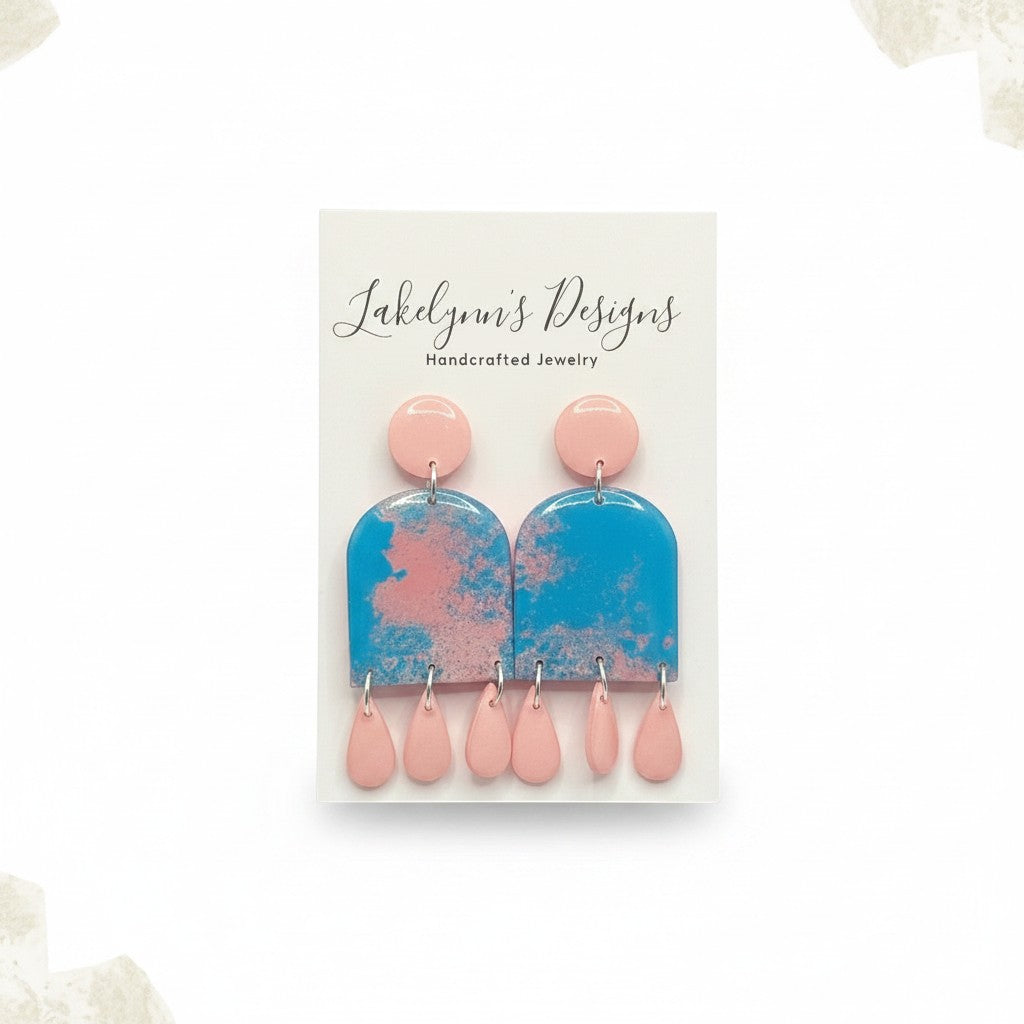 Lakelynns Designs blue marbled arch dangle earrings with pink teardrop accents. Lightweight polymer clay.