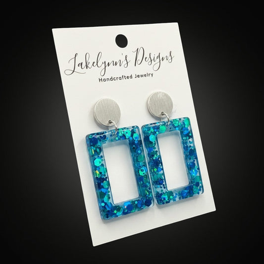 Lakelynns Designs blue and teal glitter resin rectangle drop earrings with silver stud.