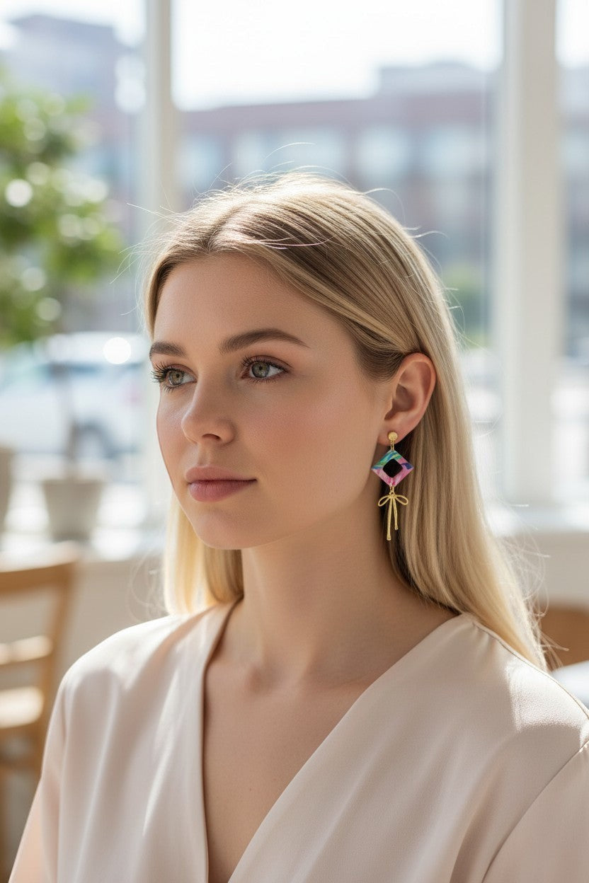 Lakelynns Designs Camila dangle earrings with abstract rhombus charm and gold bow accent.