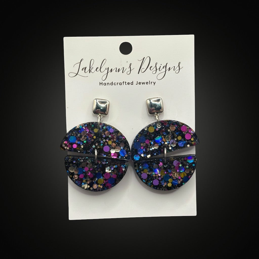 Lakelynns Designs Cecilia glitter hoop earrings with geometric cutouts and silver square studs. Iridescent glitter in clear resin.
