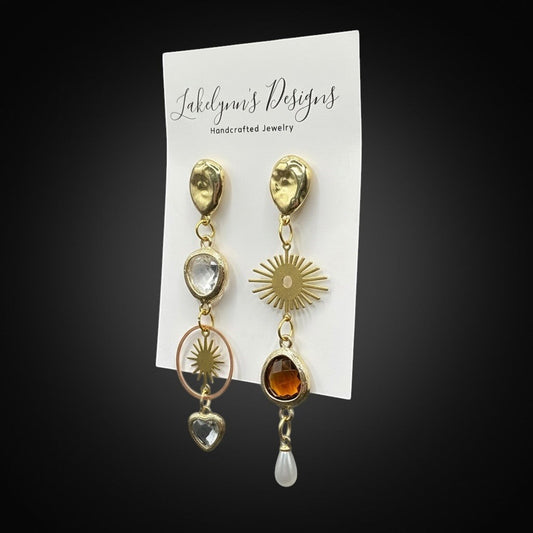 Lakelynns Designs gold-tone dangle earrings with clear and amber gemstones, sun, star, and heart charms.