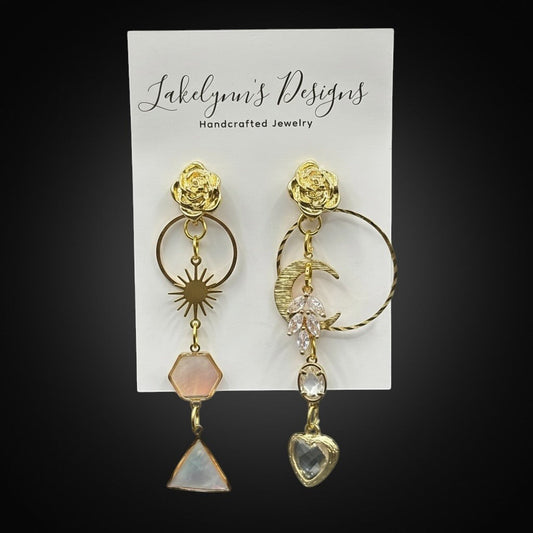 Lakelynns Designs asymmetrical gold-tone dangle earrings with rose, sun, moon, and gemstone charms.