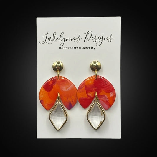 Lakelynns Designs abstract fan earrings with marbled orange, red, purple design and clear gemstone drop.