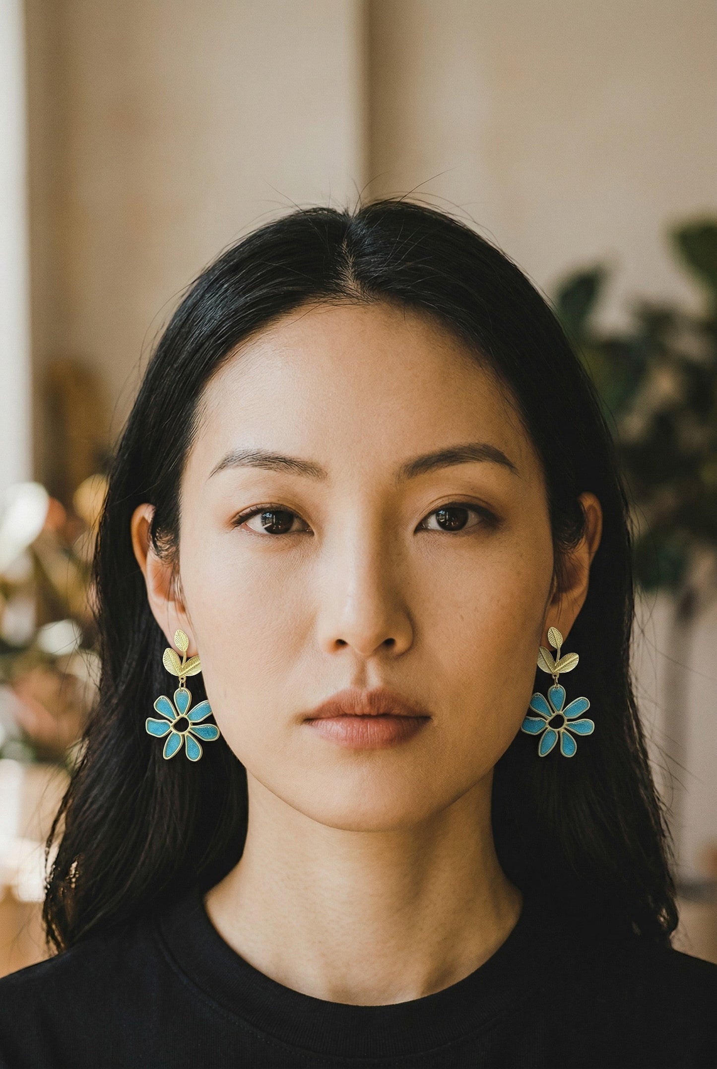 Lakelynns Designs Petal Floral Dangle Earrings with turquoise-blue resin flowers and gold leaves.