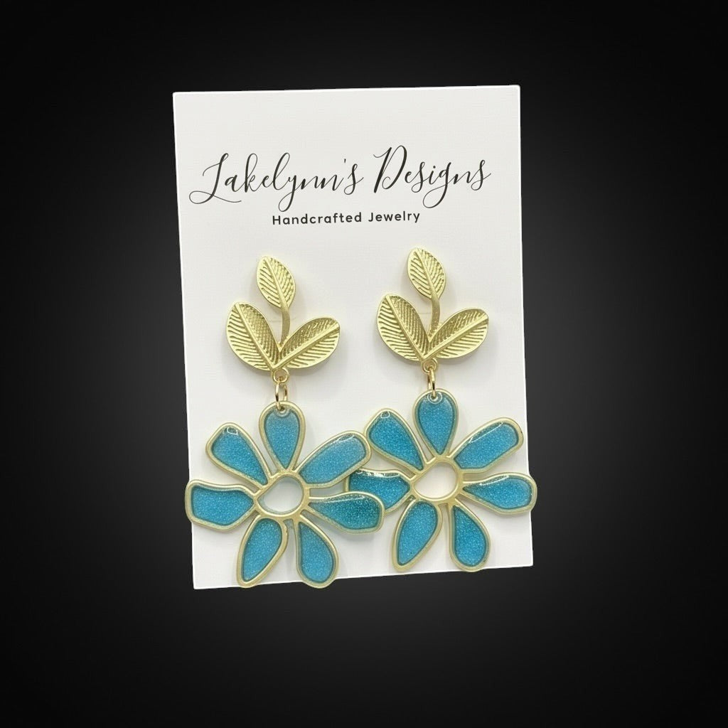 Lakelynns Designs gold-toned leaf and turquoise floral resin dangle earrings.