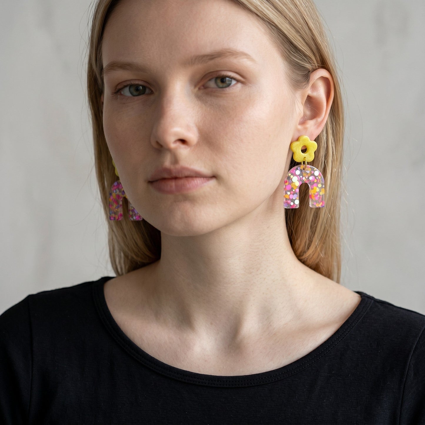 Lakelynns Designs yellow flower stud earrings with translucent glitter-filled arches in pink, purple, and yellow.