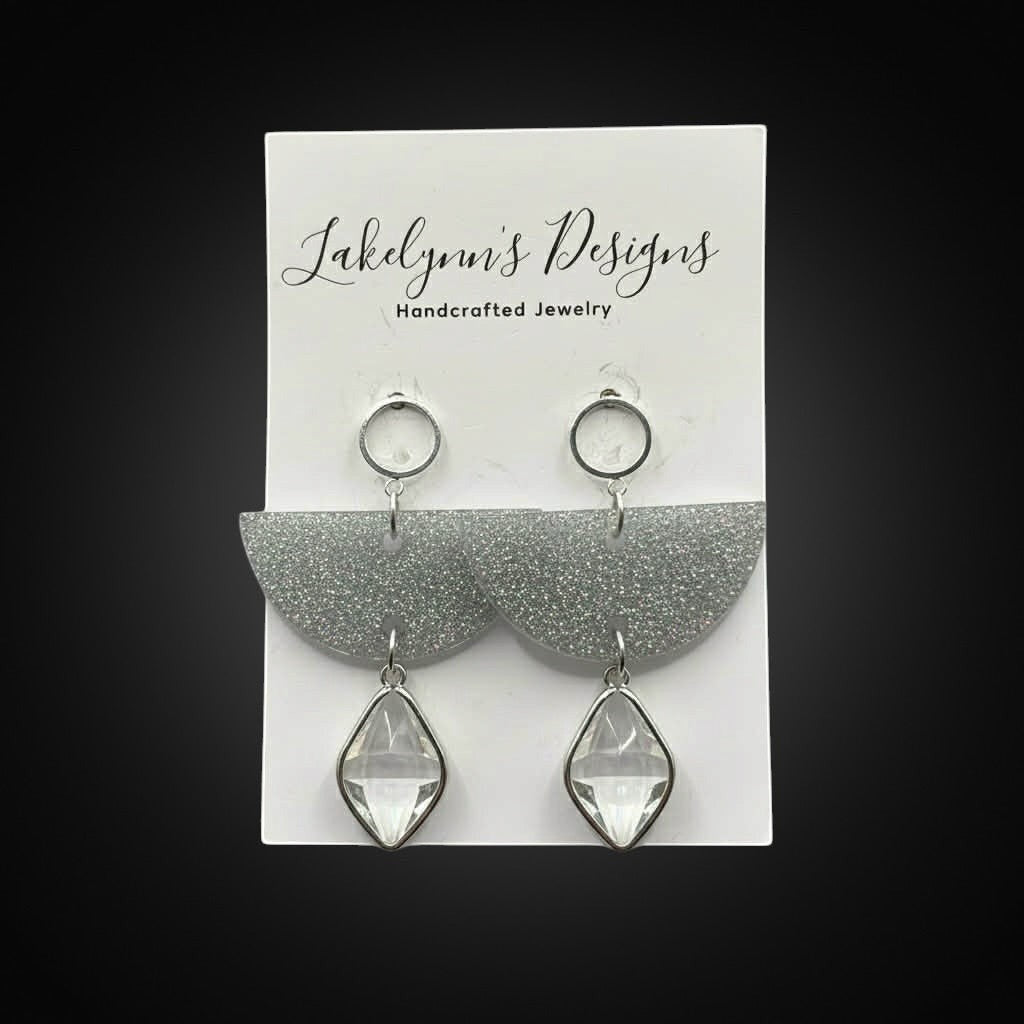 Lakelynns Designs silver glitter semicircle earrings with clear faceted gemstone drops. Modern geometric dangle earrings.