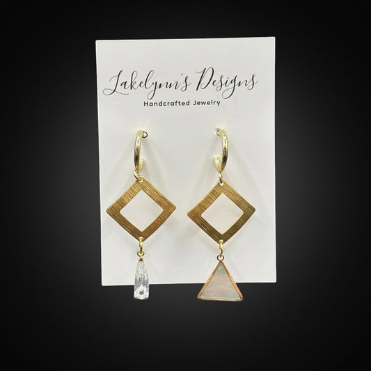 Lakelynns Designs asymmetrical geometric hoop earrings with brushed gold-tone finish, diamond shape, crystal drop, and mother-of-pearl triangle.