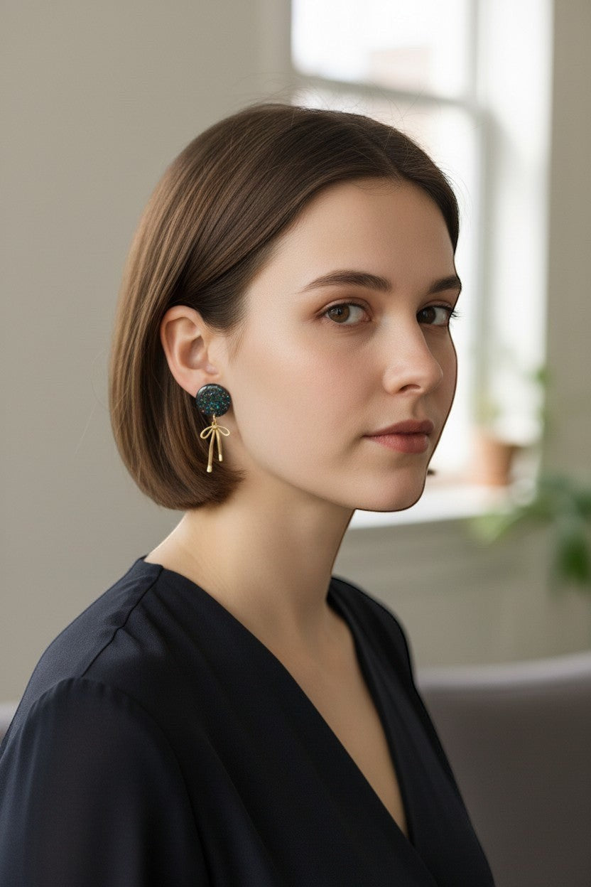Lakelynns Designs round glitter earrings with gold-tone bow dangle, dark blue glitter.
