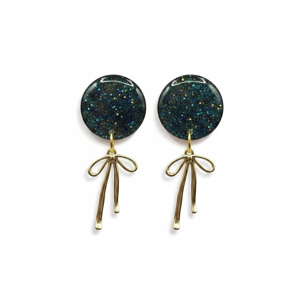 Lakelynns Designs round glitter earrings with gold-tone bow dangle. Dark green glitter studs with gold accents.