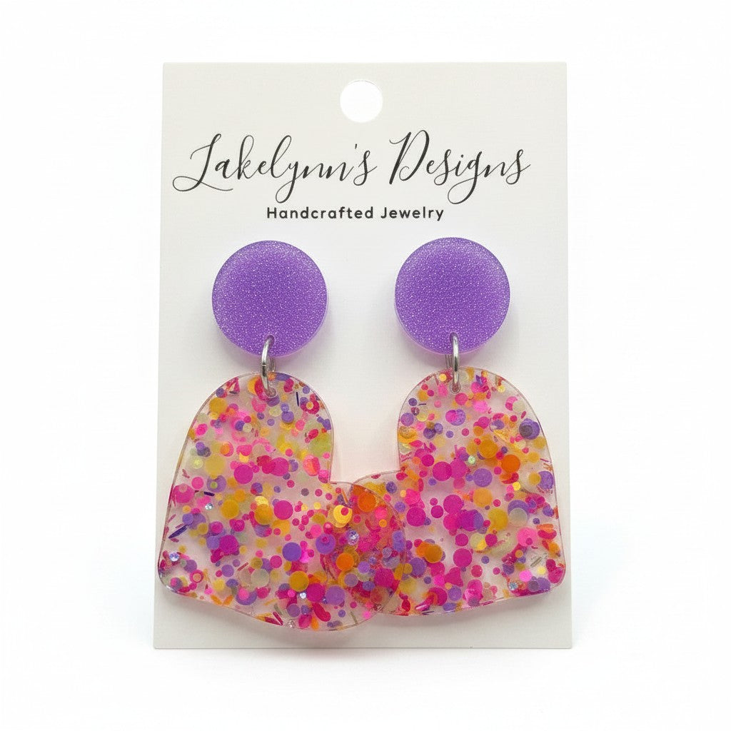 Lakelynns Designs multi-colored glitter heart dangle earrings with purple glitter stud.