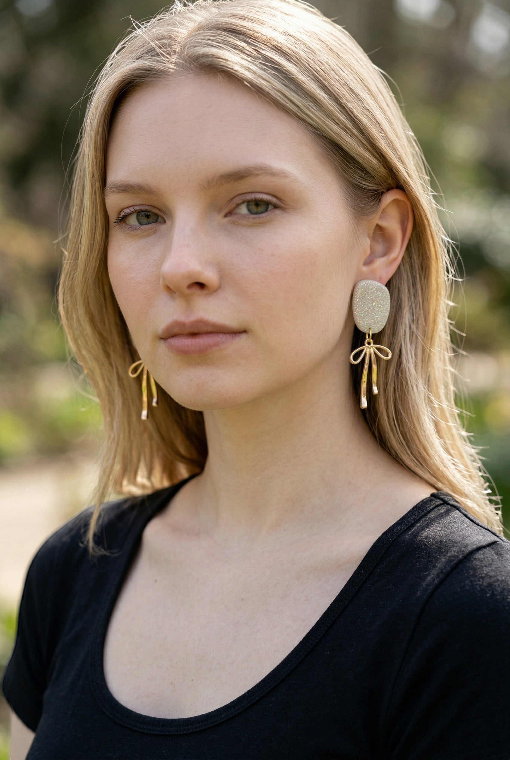 Lakelynns Designs Kinsley Glitter Oval Dangle Earrings with gold-tone bow charms.