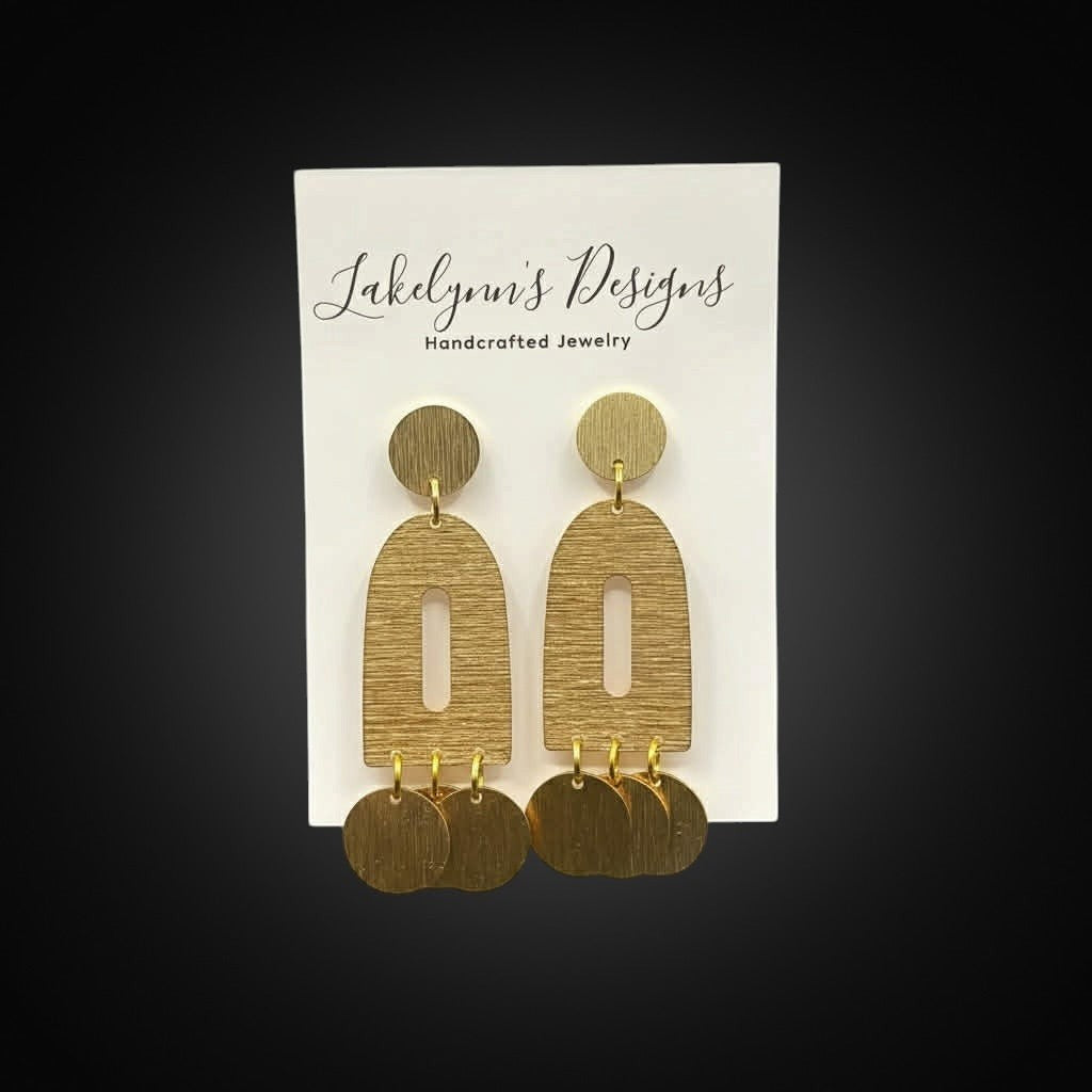 Lakelynns Designs modern arch dangle earrings in brushed gold with textured finish and dangling coin charms.
