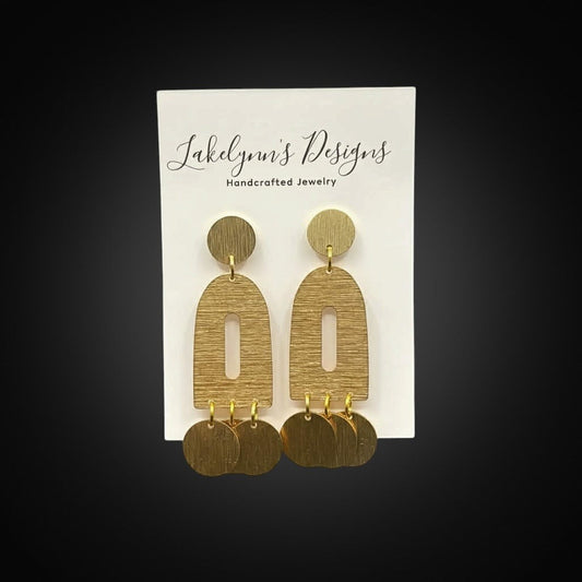Lakelynns Designs modern arch dangle earrings in brushed gold with textured finish and dangling coin charms.