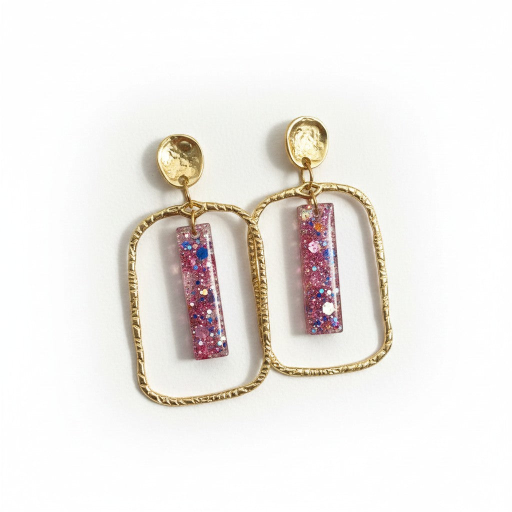 Lakelynns Designs gold frame glitter bar earrings with pink, blue, and iridescent glitter in clear resin.