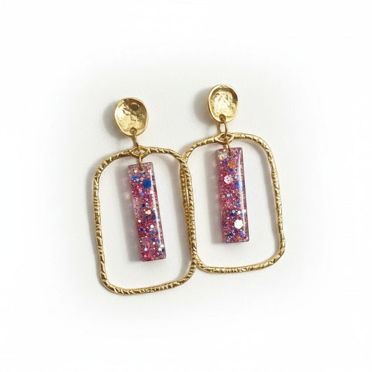 Lakelynns Designs gold frame glitter bar earrings with pink, blue, and iridescent glitter in clear resin.