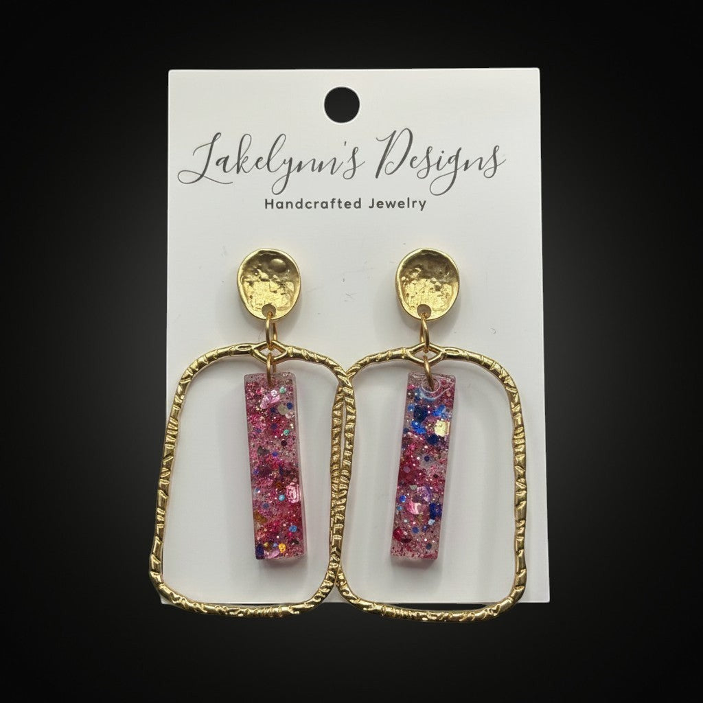 Lakelynns Designs gold frame glitter bar earrings with pink, blue, and iridescent glitter in clear resin.
