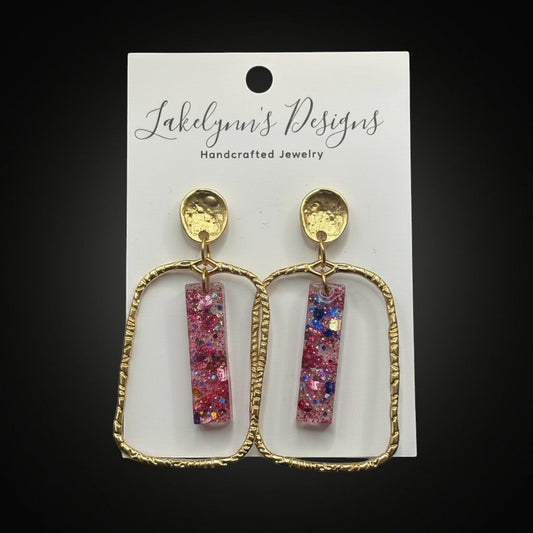 Lakelynns Designs gold frame glitter bar earrings with pink, blue, and iridescent glitter in clear resin.