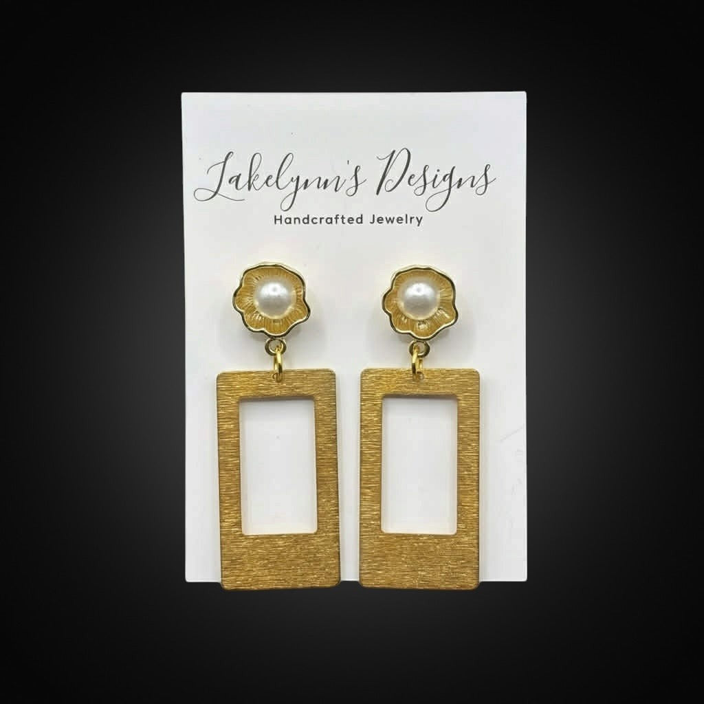 Lakelynns Designs gold rectangular frame earrings with pearl accents resembling flowers. Brushed gold finish.