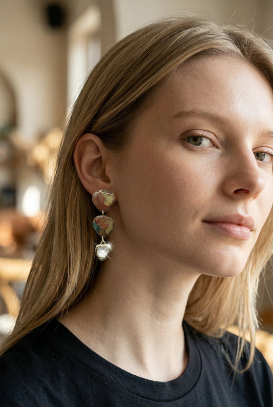 Lakelynns Designs marbled rust, gold, and green heart-shaped dangle earrings with a clear faceted heart charm.