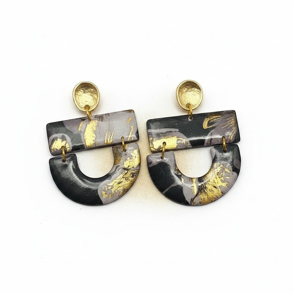 Lakelynns Designs Hollis dangle earrings with abstract black, grey, and gold marbled pattern. Lightweight polymer clay with gold-toned hardware.