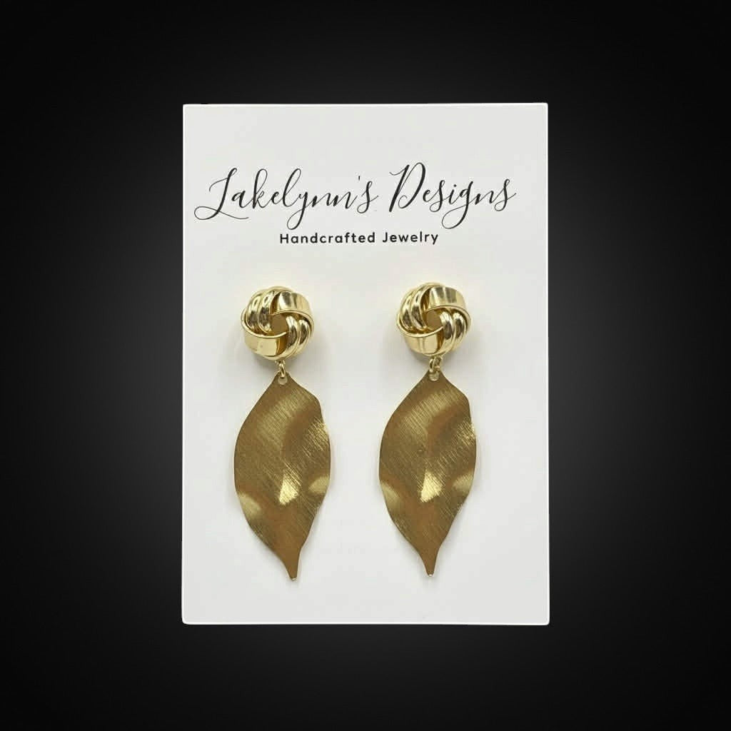 Lakelynns Designs gold-tone knotted leaf dangle earrings with brushed finish.
