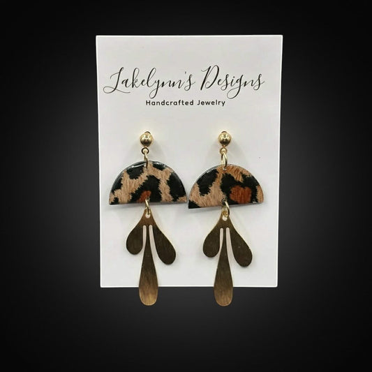 Lakelynns Designs leopard print dangle earrings with abstract gold charms. Semi-circular top with animal print.