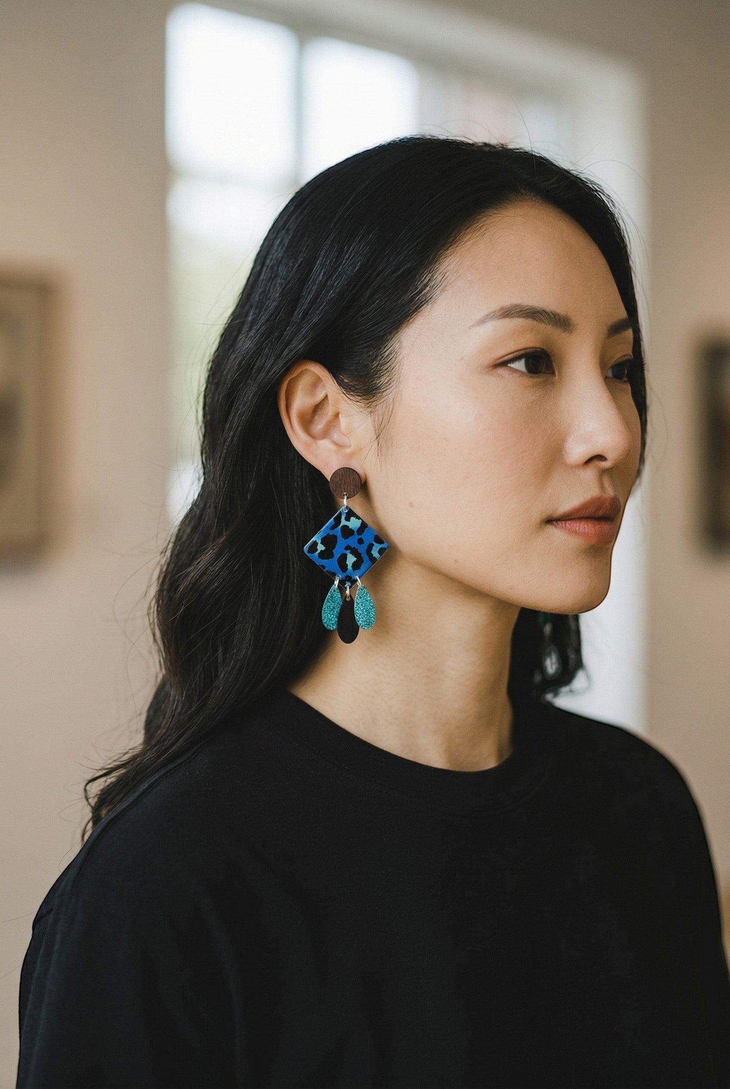 Lakelynns Designs blue leopard print diamond drop earrings with turquoise and black teardrop charms and wood bead.