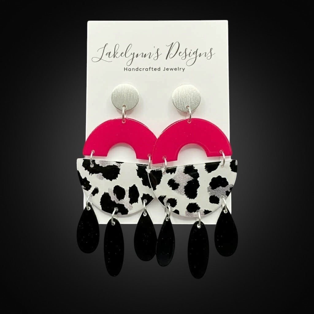 Lakelynns Designs Maya Dangle Earrings: hot pink semi-circles, cow print acrylic, and black teardrop dangles with silver studs.